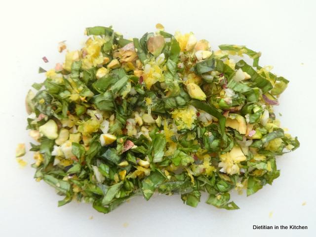 Mixed pistachio basil gremolata on a cutting board. 