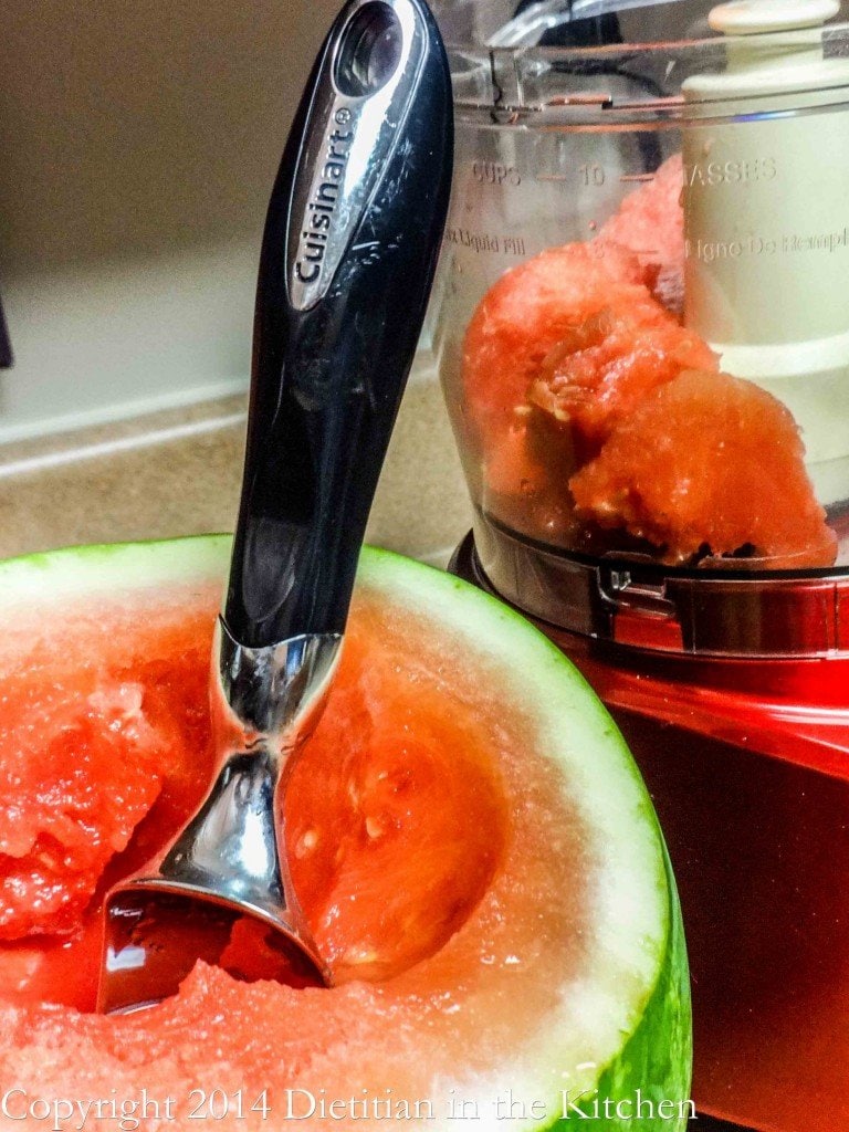 Scooping Watermelon for a drink.