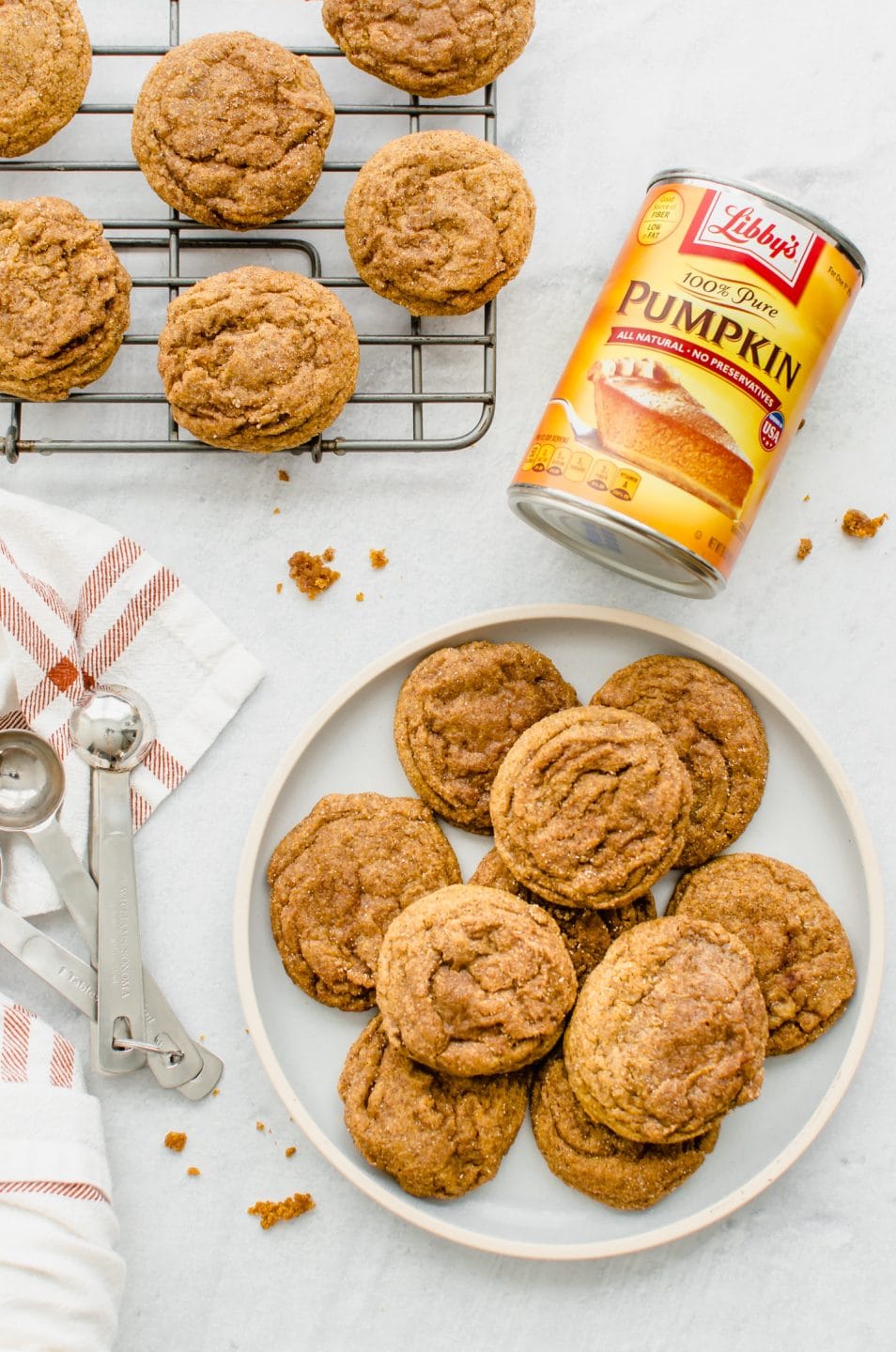 A plate of Pumpkin Cookie Butter Doodles with a can of pumpkin puree on the side. 