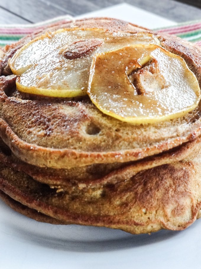 Gingerbread Pear Pancakes made with ½ whole grains. They are super light and fluffy with plenty of gingerbread spice! www.sweetcayenne.com