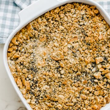 Baked poppy seed chicken casserole in a white baking dish.