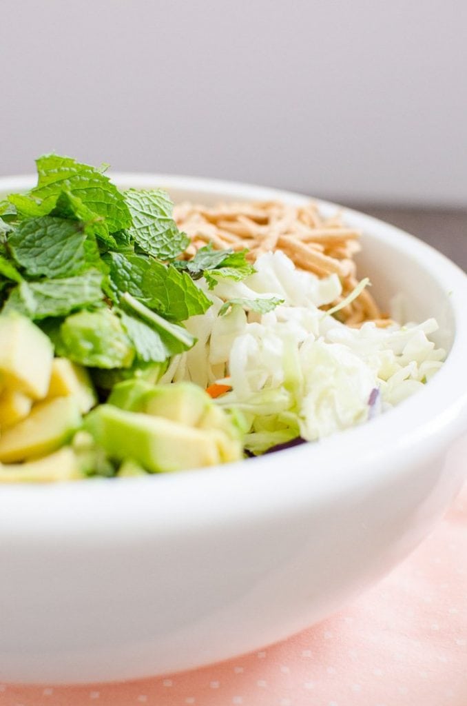 A close up view of awhite bowl with Chow Mein Chopped Salad.