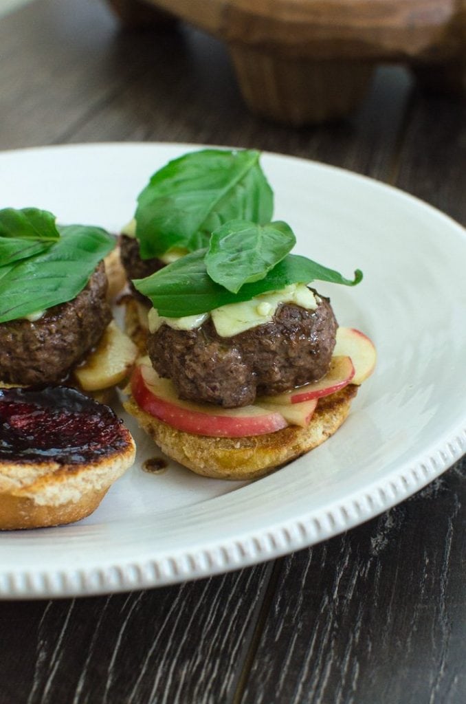 Blackberry Basil Sliders are fun summer to fall transition burger that joins the flavor of fresh summer herbs and preserves with fall apples. Try them for Labor Day or your next tailgate!