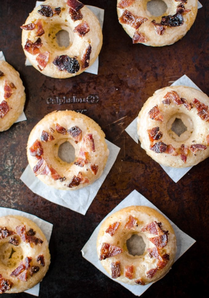Maple Bacon Donuts are baked, not fried, for a lower-fat but delicious indulgence. Dipped in a brown butter maple glaze and crispy pieces of candied bacon!