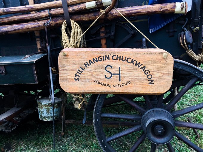 A chuck wagon with a wooden sign.