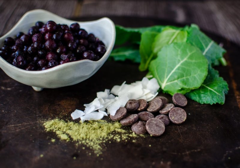 Chocolate Covered Wild Blueberry Superfoods Smoothie is made with highly flavored wild blueberries and packed with nutrition! A chocolate-coconut oil mixture is drizzled into the smoothie and blended, turning it into little chips of chocolate in the smoothie. It's like homemade magic shell in your drink!