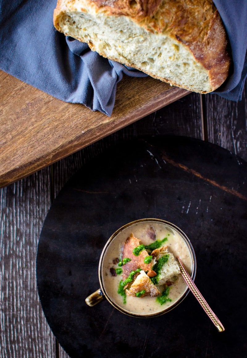 Cauliflower soup on a black soapstone tray.