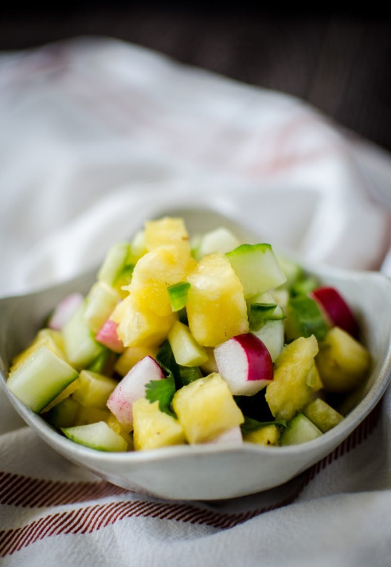 A bright and colorful pineapple salsa adds the perfect touch to fish taco bowls and is filled with spring produce like pineapple, cucumber, and radishes.