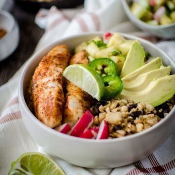 If you like "bowl food," you'll love this fresh and flavorful taco bowls with spicy pan-seared fish, plantain fried rice, black beans, and a juicy pineapple salsa! A fun take on an easy fish taco recipe.