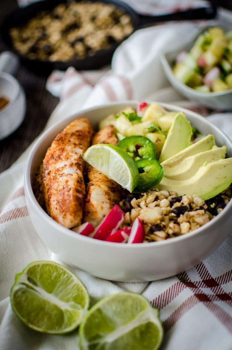 If you like "bowl food," you'll love this fresh and flavorful taco bowls with spicy pan-seared fish, plantain fried rice, black beans, and a juicy pineapple salsa! A fun take on an easy fish taco recipe. 