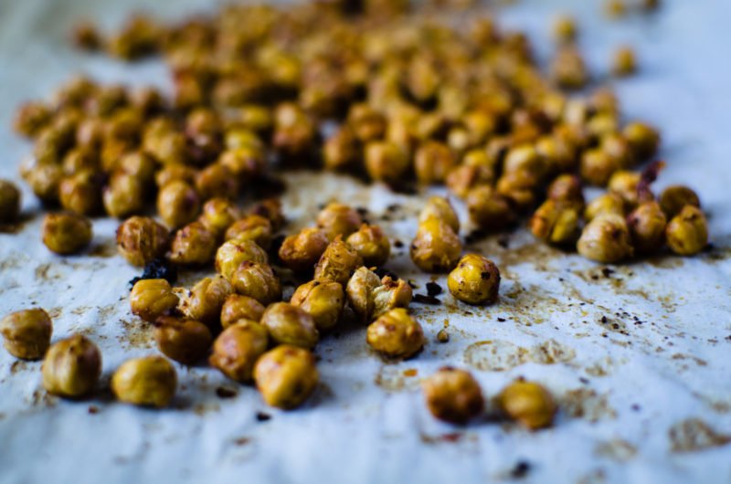 Hot and crispy roasted chickpeas are spiced with a coating of smokey harissa sauce and make an amazing roasted snack! Super simple to make - you will love them!