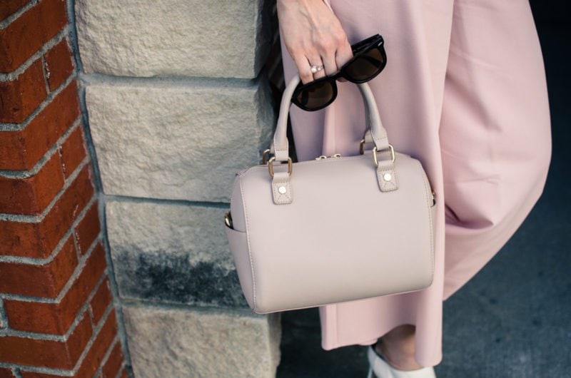 Blush pink culottes paired with a cropped black shell and Sam Edelman heels with a nude bag and necklace. Elegant spring outfit idea!