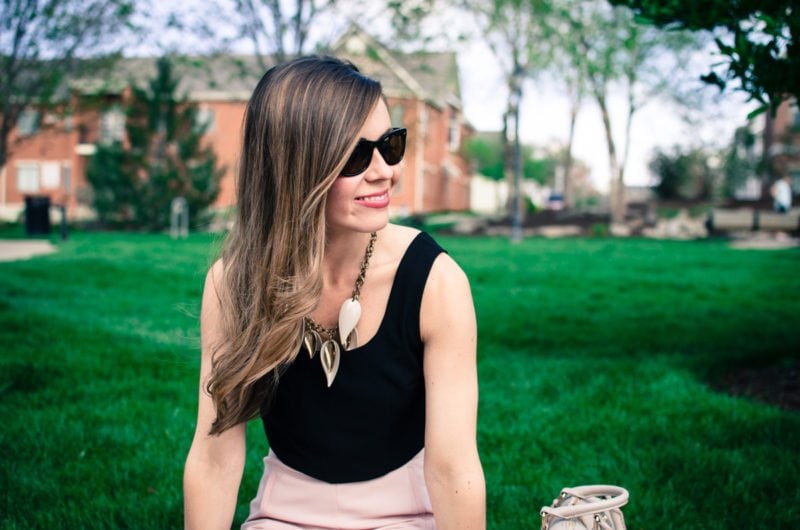 Blush pink culottes paired with a cropped black shell and Sam Edelman heels with a nude bag and necklace. Elegant spring outfit idea!