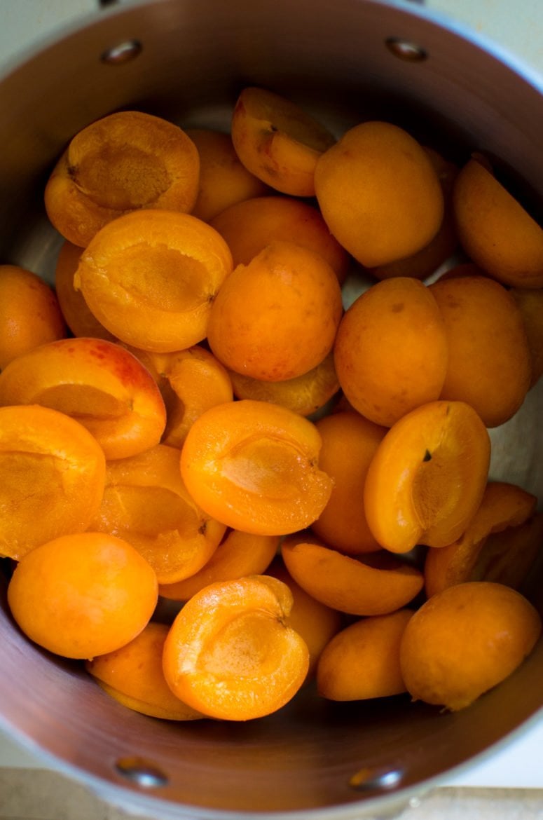 Halved apricots in a pot.