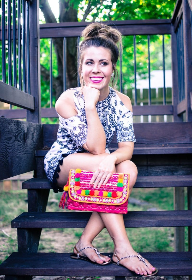 Pom Pom and tassel details are one of the summer's hottest fashion trends. This look features a pom pom clutch and cold shoulder romper with tassel detail. 