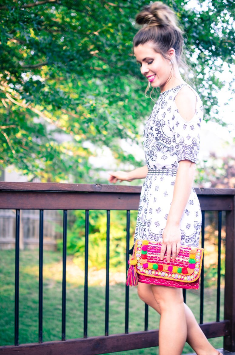 Pom Pom and tassel details are one of the summer's hottest fashion trends. This look features a pom pom clutch and cold shoulder romper with tassel detail. 