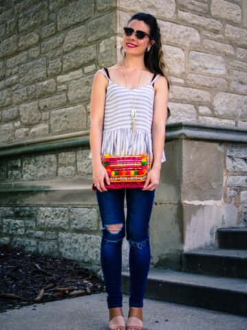 This laid back summer outfit idea feature a soft cotton Asos tank, distressed jeans and a colorful pom pom clutch!