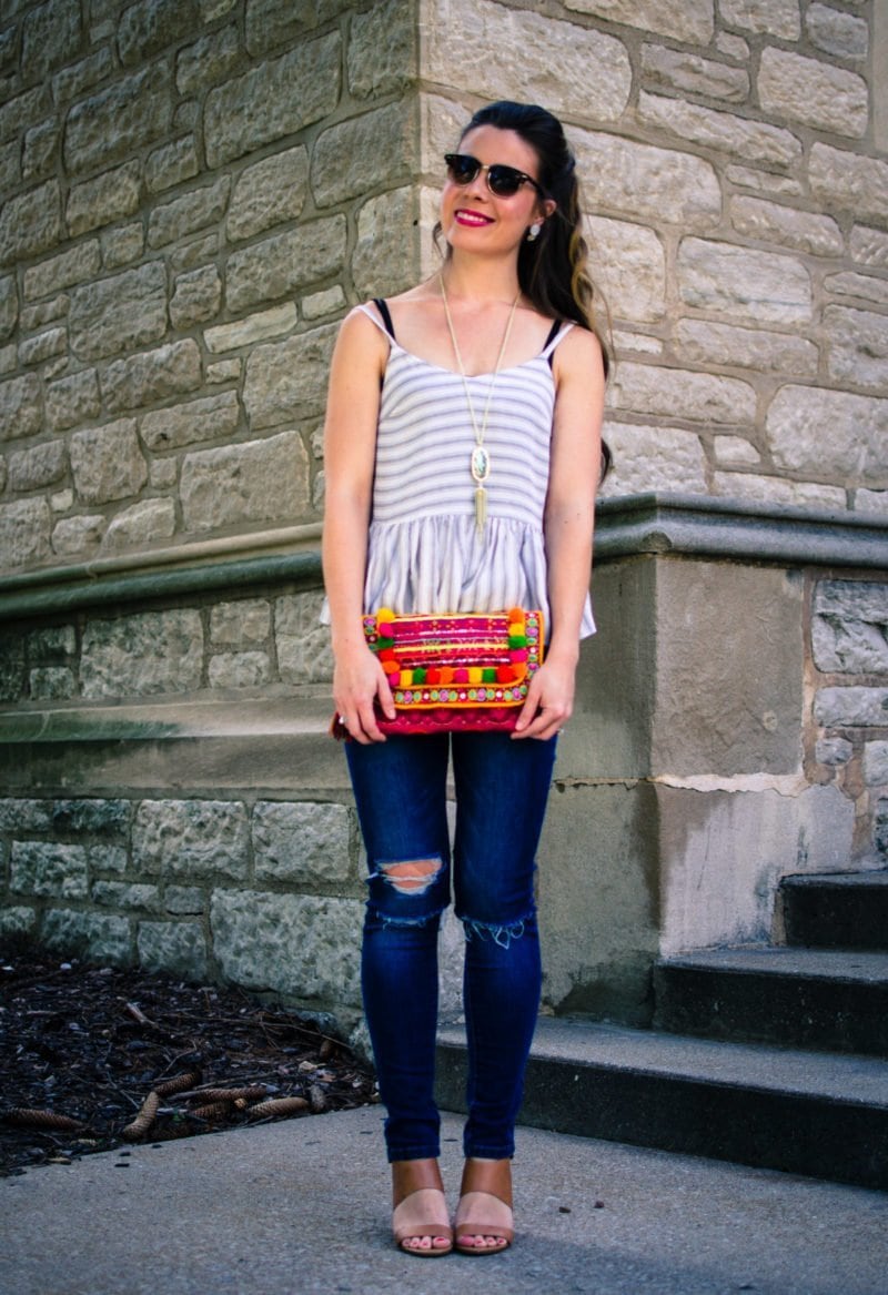 This laid back summer outfit idea feature a soft cotton Asos tank, distressed jeans and a colorful pom pom clutch!