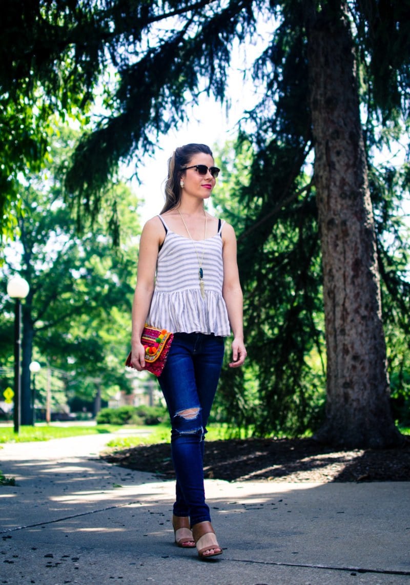 This laid back summer outfit idea feature a soft cotton Asos tank, distressed jeans and a colorful pom pom clutch!