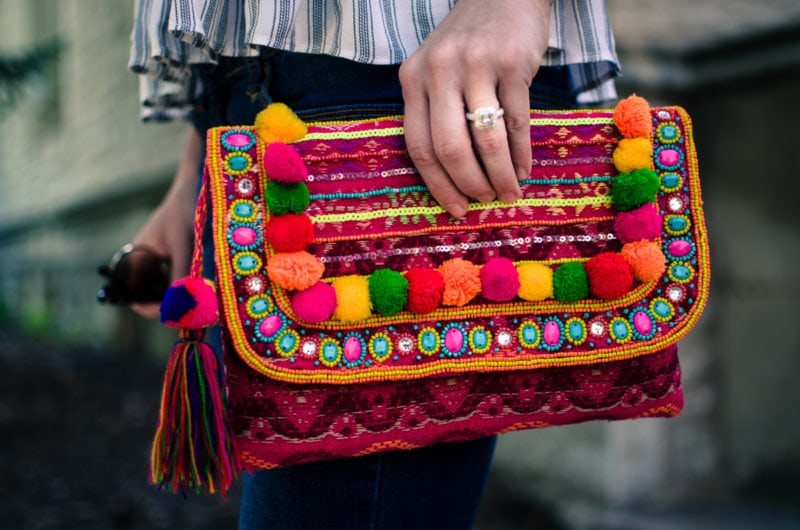 This laid back summer outfit idea feature a soft cotton Asos tank, distressed jeans and a colorful pom pom clutch!