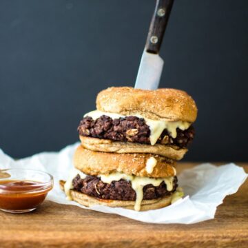 This vegetarian black bean burger recipe is the perfect option for game day. It's smothered in a Hatch chile quest and smoky BBQ sauce.