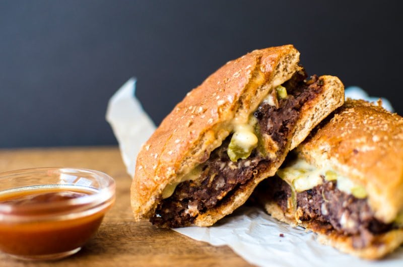 This vegetarian black bean burger recipe is the perfect option for game day. It's smothered in a Hatch chile quest and smoky BBQ sauce. 