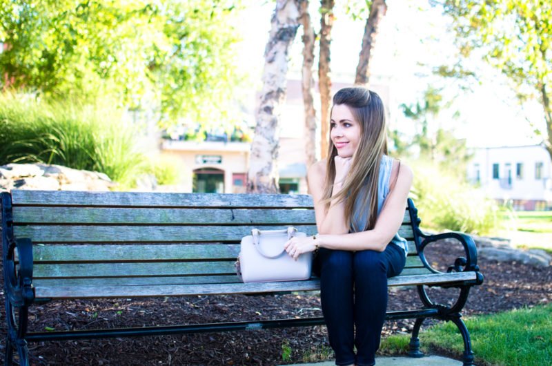 A chic and sophisticated denim on denim look that's perfect for fall transition fashion. High waisted jeans in a dark wash with an open-back chambray shirt. 