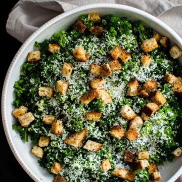 This simple kale salad recipe is the perfect vehicle for creative toppings, homemade croutons, and can be used as a side dish or as sandwich filling!