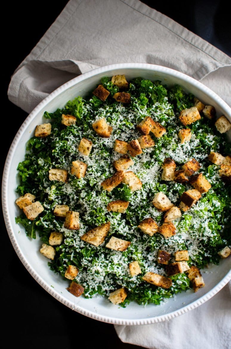 This simple kale salad recipe is the perfect vehicle for creative toppings, homemade croutons, and can be used as a side dish or as sandwich filling!