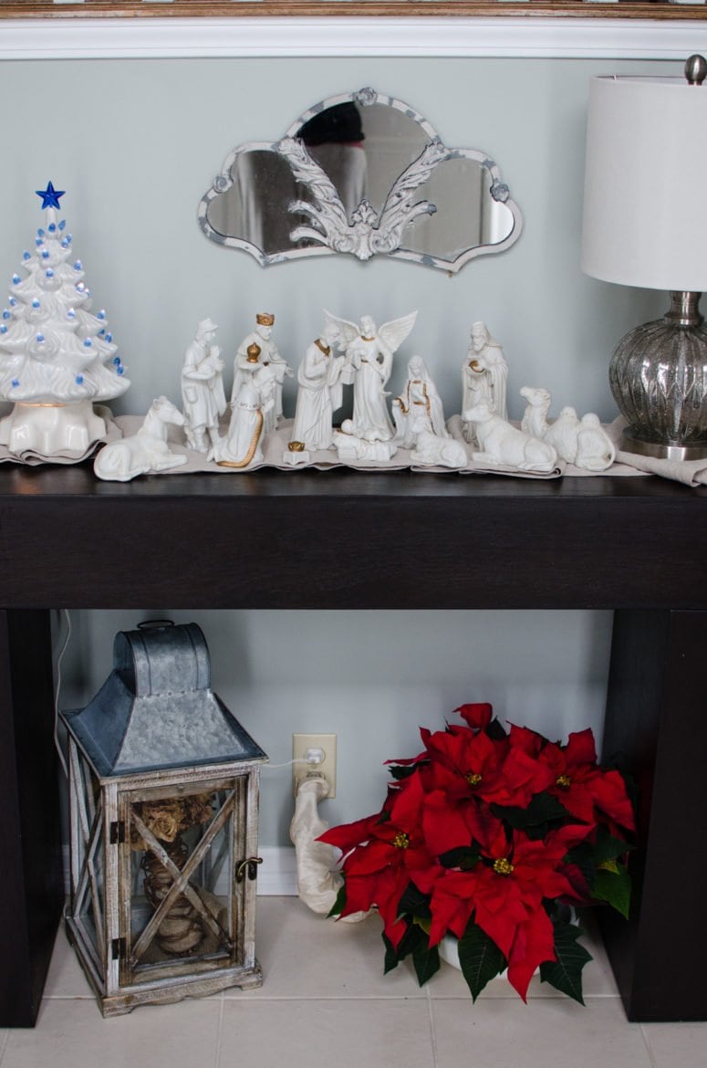 Our entry Christmas decor includes a white porcelain manger set from my Grandmother, a vintage light up Christmas tree, and a lovely poinsettia. 