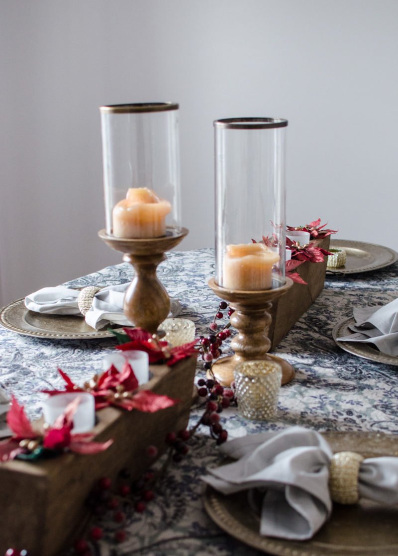 My dining room table is accented with blonde wood pillar candles, sugar mold centerpieces filled with candles and Christmas floral, and a cranberry garland