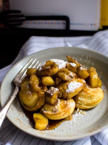 This recipe for filled pancakes, also known as Ebelskivers, are filled with a butter Bananas Foster compote and are the perfect way to put a little "hygge" into weekend brunch.