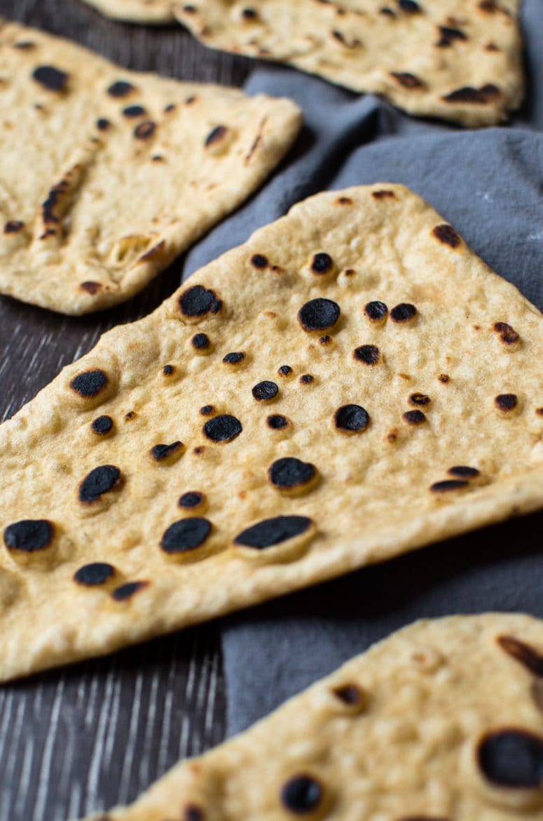 Naan bread sliced into pizza slice shape.