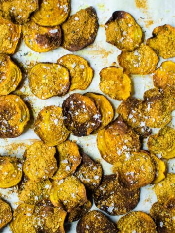These cheesy golden beet chips with turmeric and rosemary sea salt are a savory +salty alternative to regular chips and are an easy healthy snack recipe! Gluten free and vegan too!