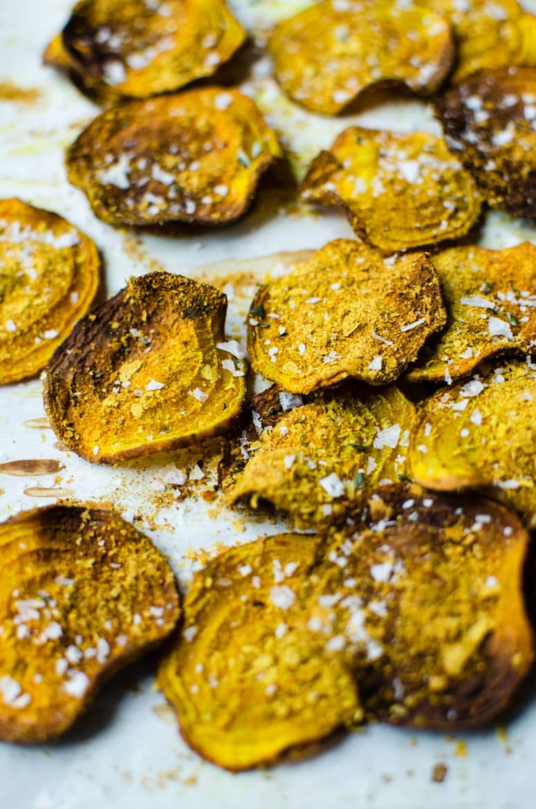 A close up shot of crispy beet chips with cheese seasoning and sea salt flakes. 