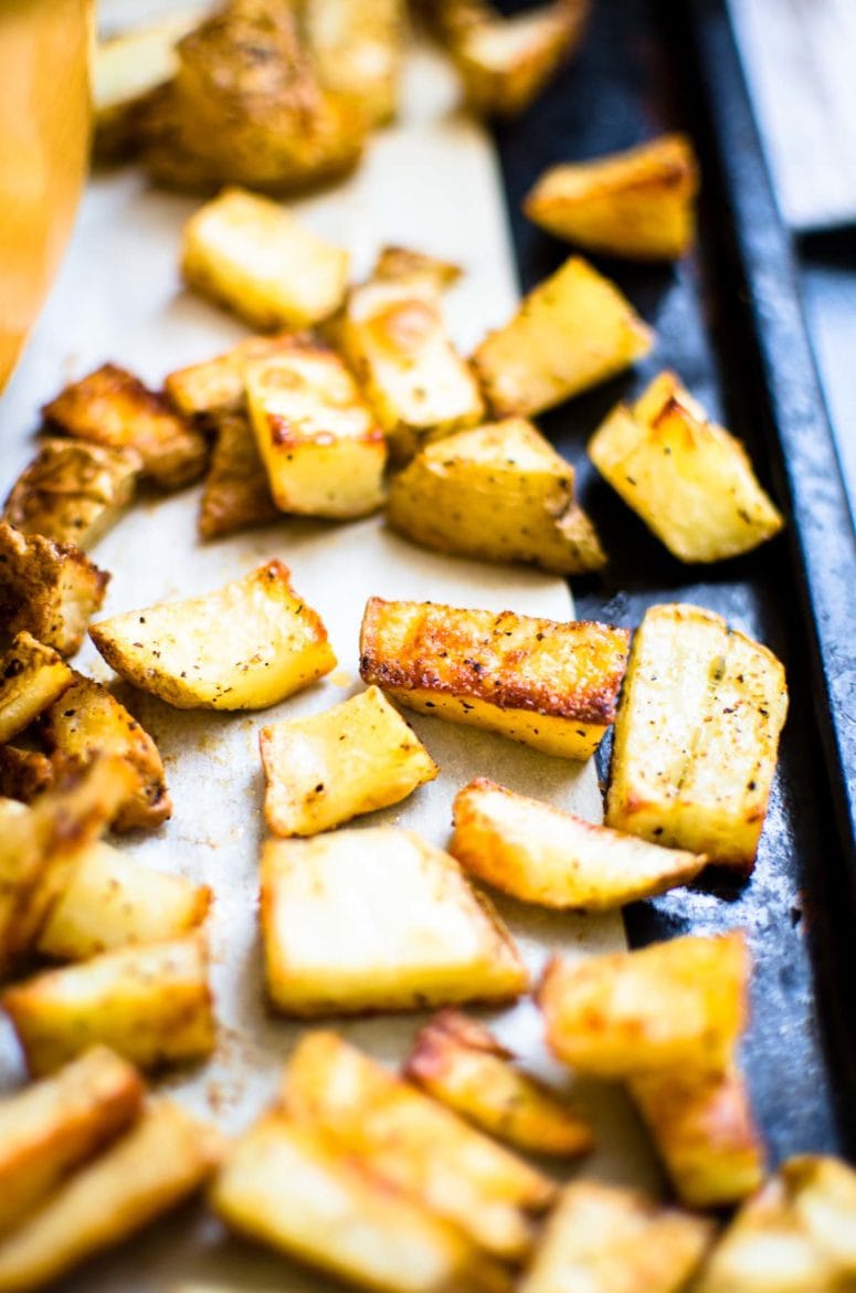 Crispy potatoes on a cooking tray, side view. 