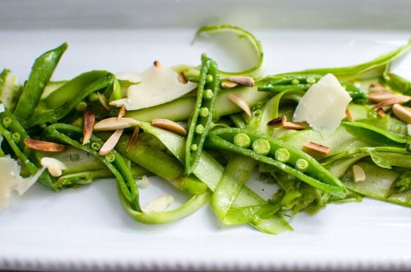 Shaved Asparagus and Sweet Pea Salad with Lemon Vinaigrette on a serving dish.