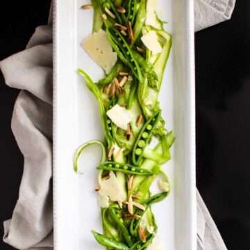 This recipe for Shaved Asparagus and Sweet Pea Salad with Lemon Vinaigrette is the most refreshing way to enjoy crisp, spring vegetables - no cooking required!