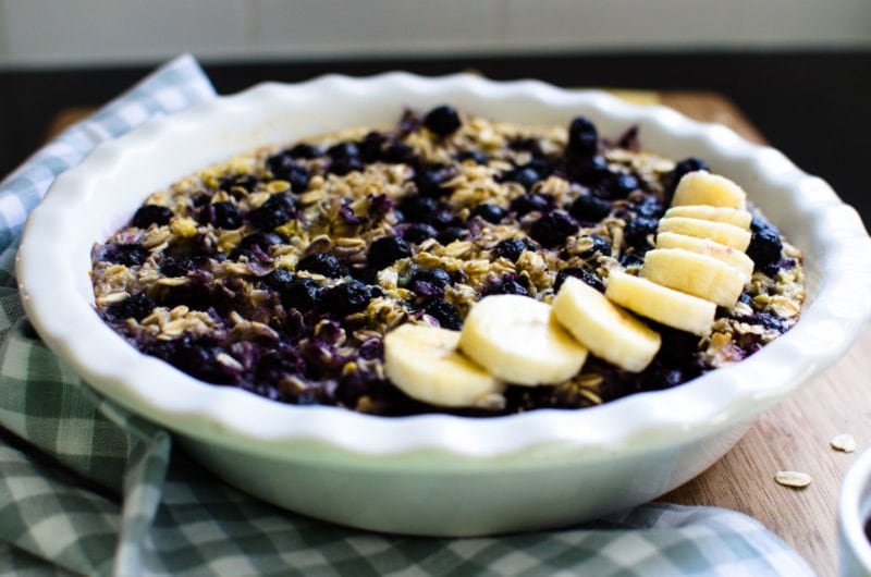 Banana blueberry oatmeal in a ceramic pie dish.