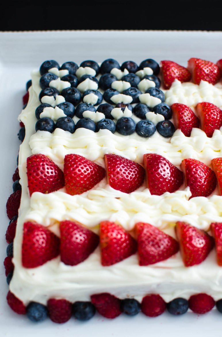 American flag cake with berries and icing. 