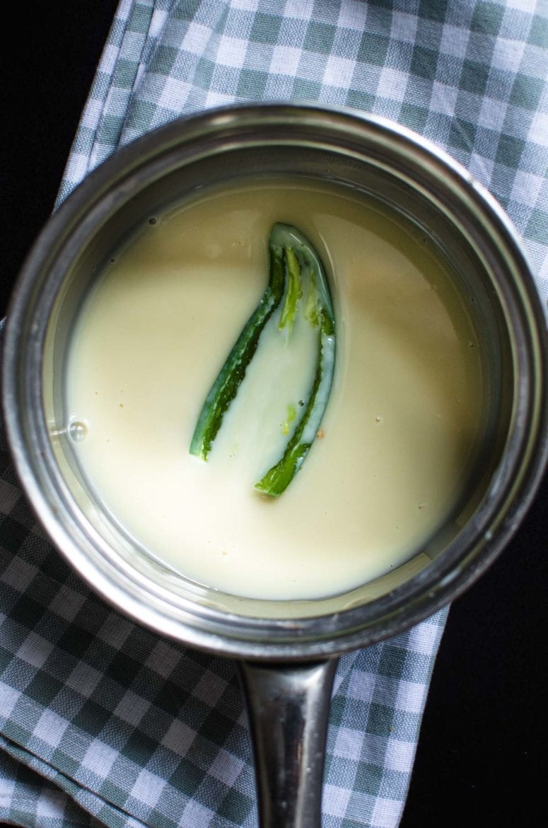 Condensed milk with a jalapeno pepper in a pot. 