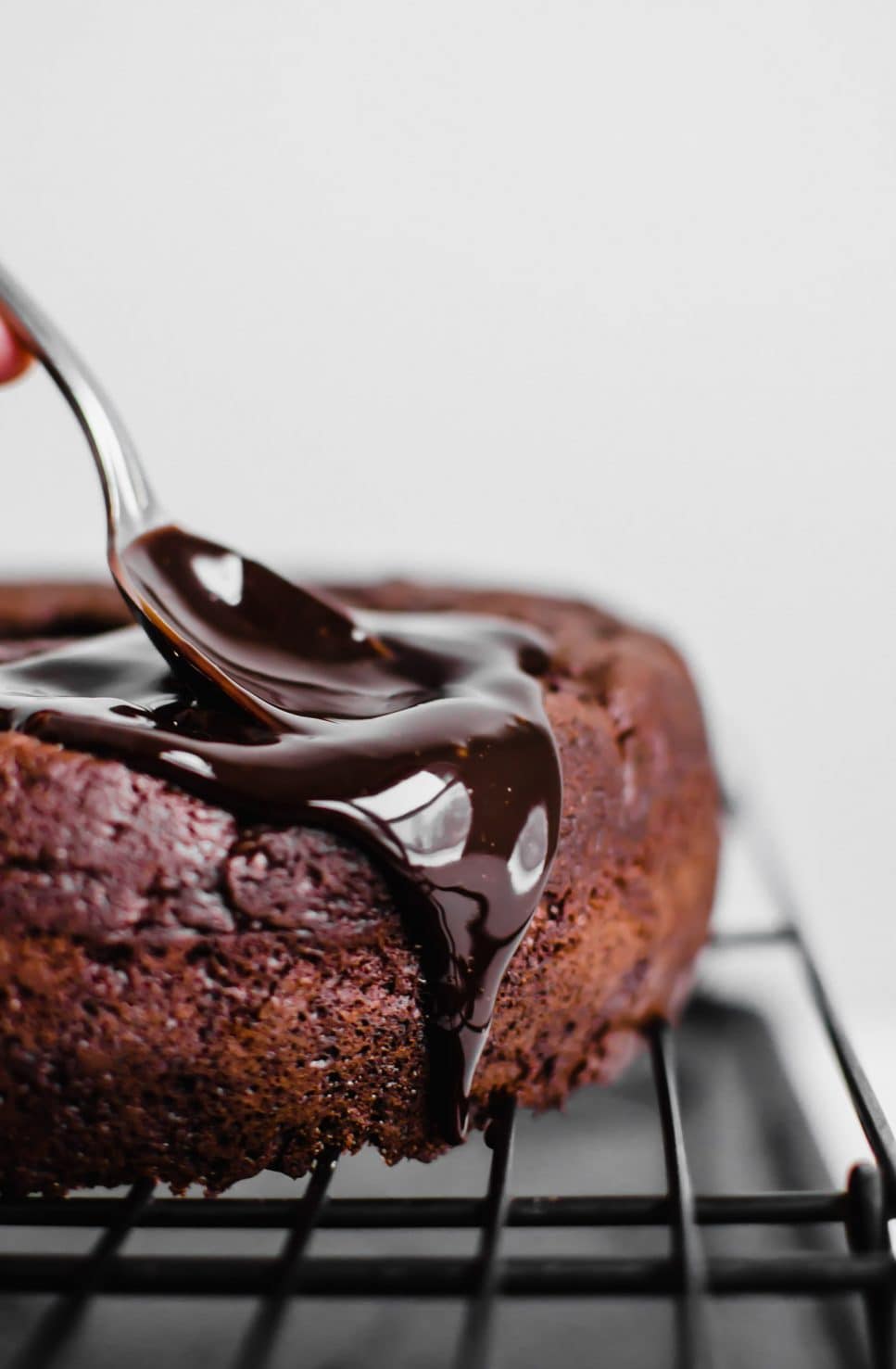 This recipe for Back Pocket Chocolate Fudge Cake is an easy bundt cake that is super moist, fudgy, and extra delicious. It's made with Ghirardelli chocolate, sour cream, and topped with hot fudge and caramel! #valentines #chocolatecake