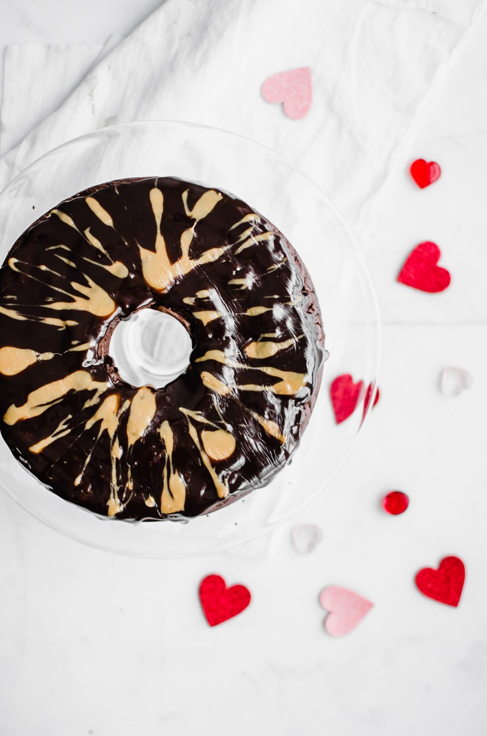 This recipe for Back Pocket Chocolate Fudge Cake is an easy bundt cake that is super moist, fudgy, and extra delicious. It's made with Ghirardelli chocolate, sour cream, and topped with hot fudge and caramel! #valentines #chocolatecake