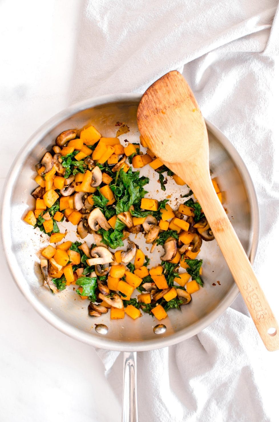 Cooking pan with butternut squash and kale.