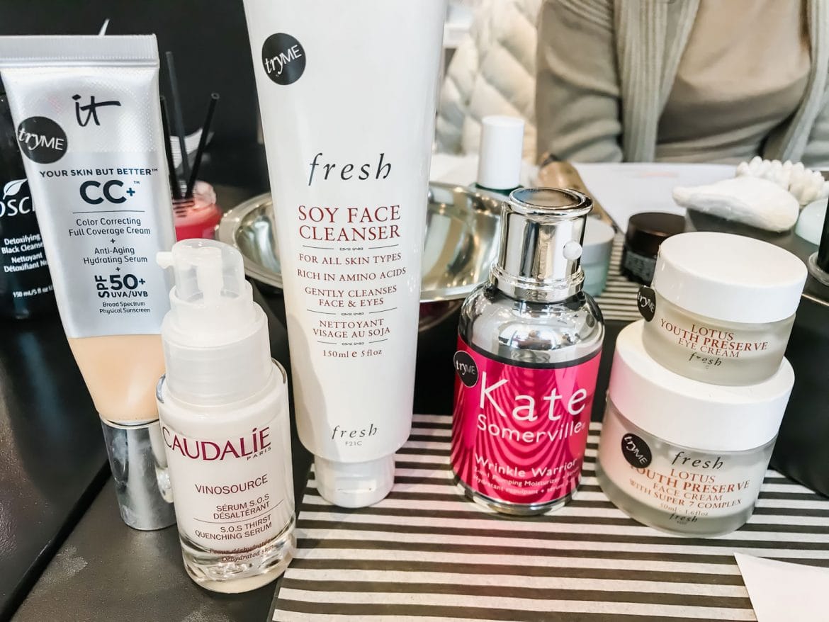 Variety of face make up products displayed on makeup counter. 