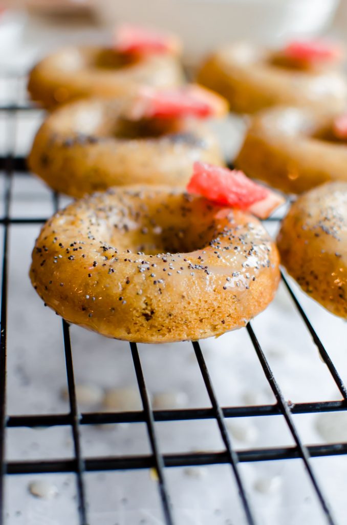 Close photo of grapefruit donut on a serving rack.