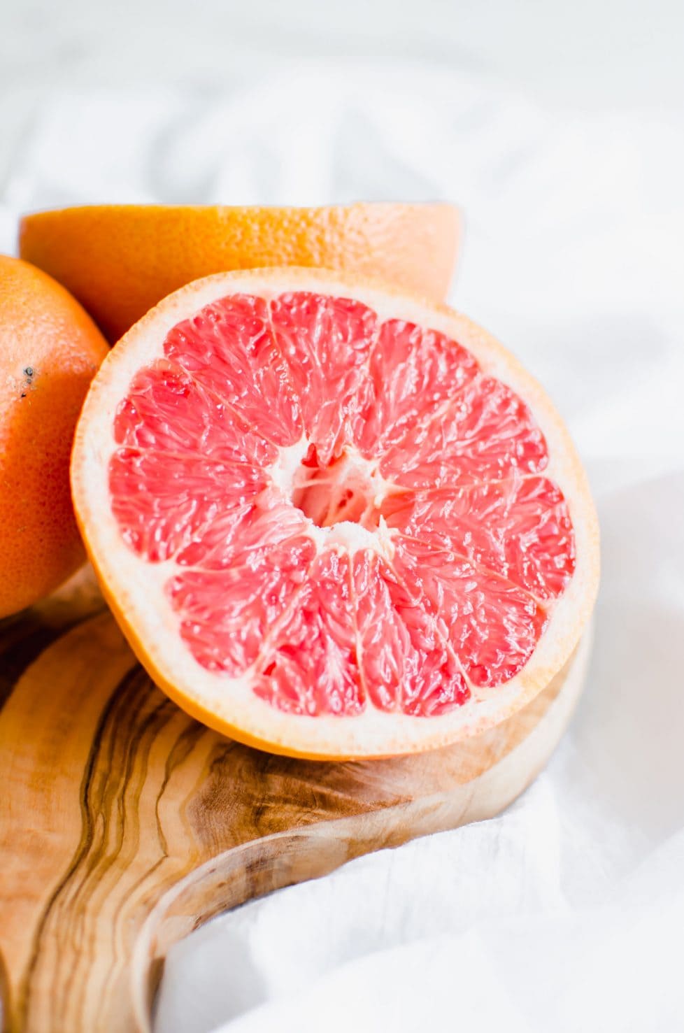 This recipe for Grapefruit Poppy Seed Donuts is perfect for a spring brunch or garden party! They are made with whole grain flour, wholesome Greek yogurt, and coconut sugar with a light citrus glaze. #grapefruit #springrecipes #sweetcayenne