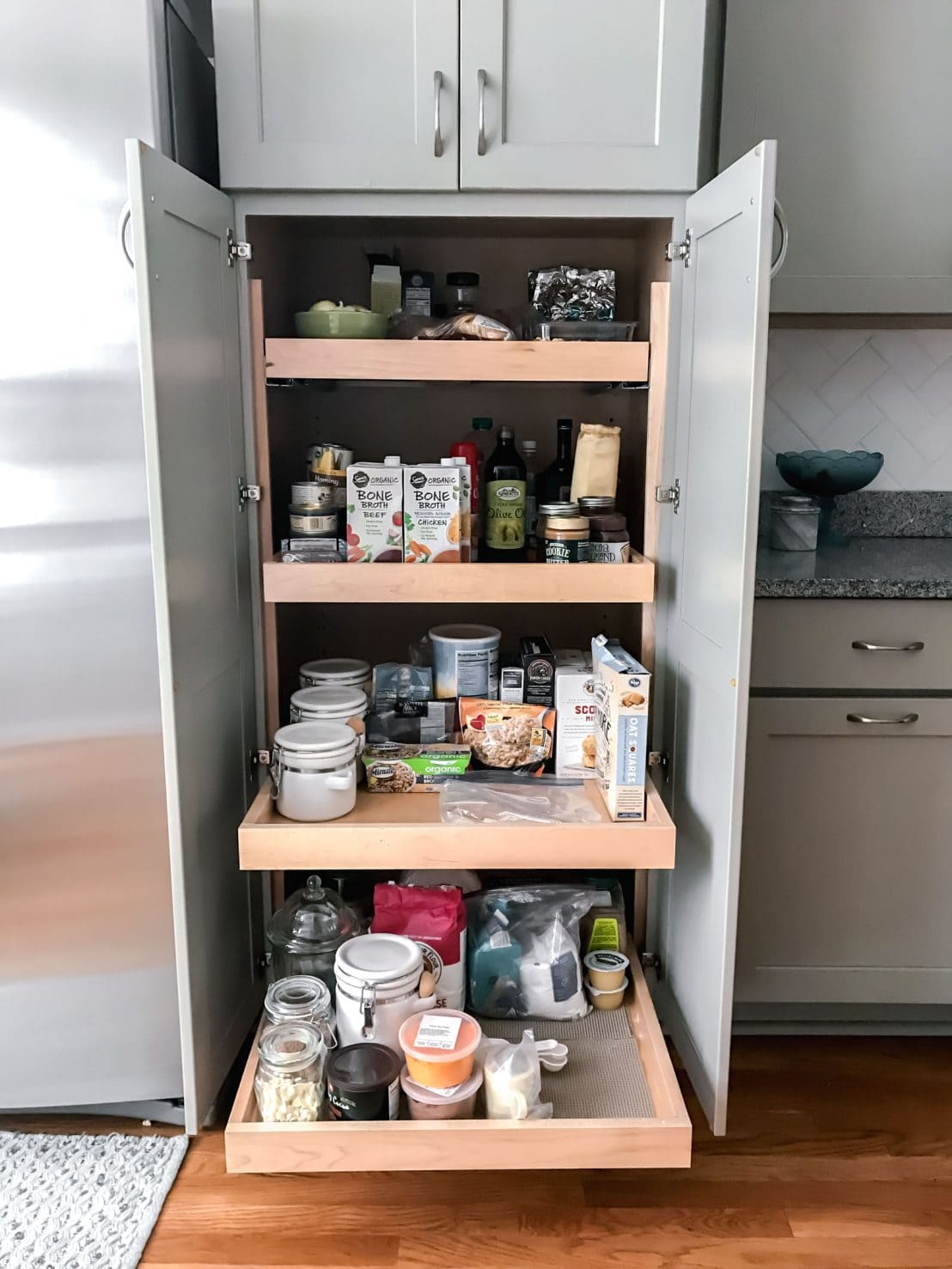 Our mini kitchen makeover featured a redo of the breakfast space. We added new paint and replaced the table with a French marble top island for prep and food photography. #homedecor #interiordesign #kitchenmakeover