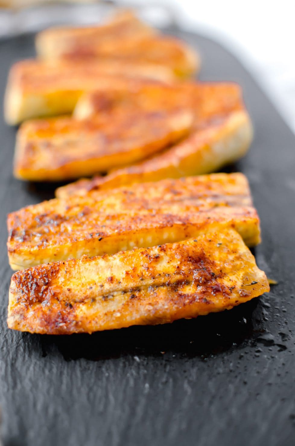 Roasted plantains on a tray. 