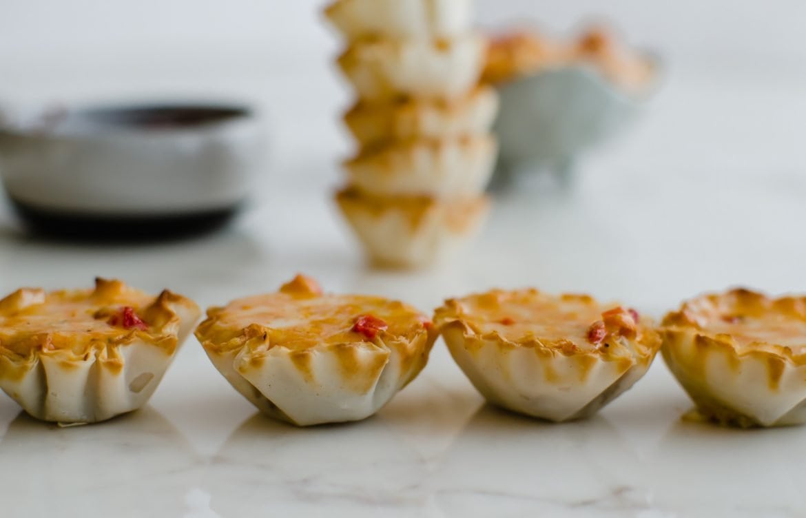 Four pimento cheese tartlets side by side